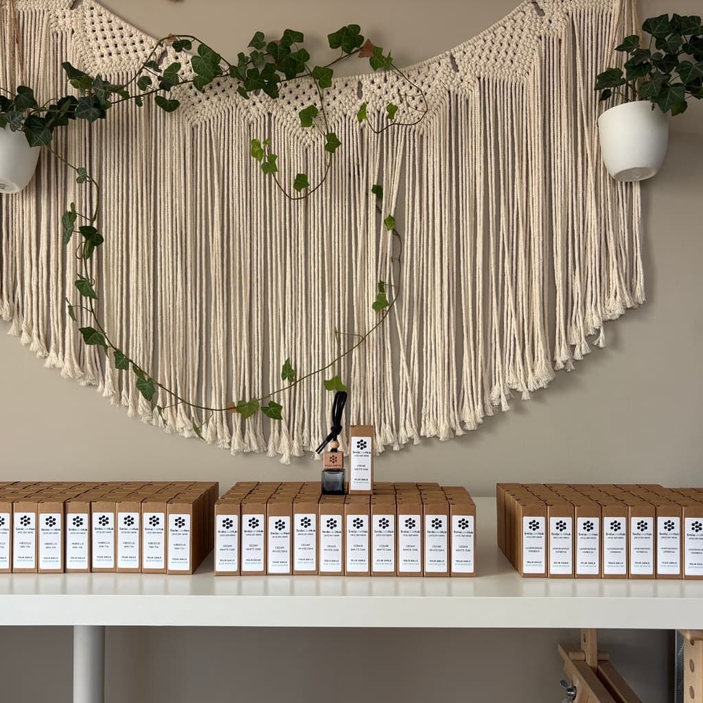 SmileLinkHub production run — shelf of branded car diffuser boxes and bottles